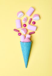 Blue waffle cone with spilled candies
