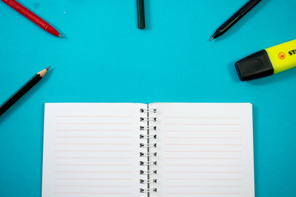 Open notebook with writing tools or school equipment
