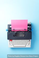 Typewriter with pink paper over blue background 4mDNz5