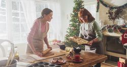 Portrait of Adult Mother and Daughter Preparing Christmas Dinner for Guests.
