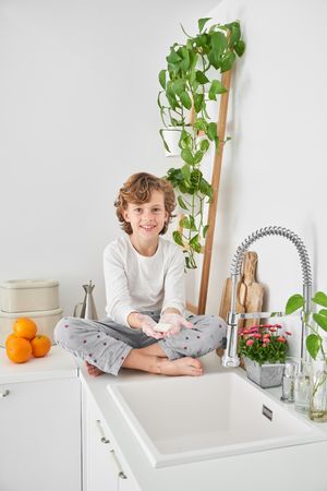 Smiling boy washing hands with bar of soap