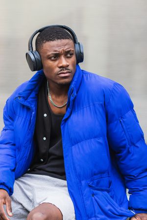 Black man listening to music in city