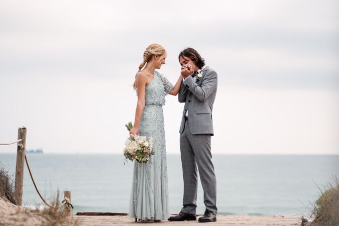 Happy young married couple spending time together at seaside