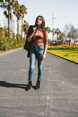 Teen girl walking happily through the streets of the city.