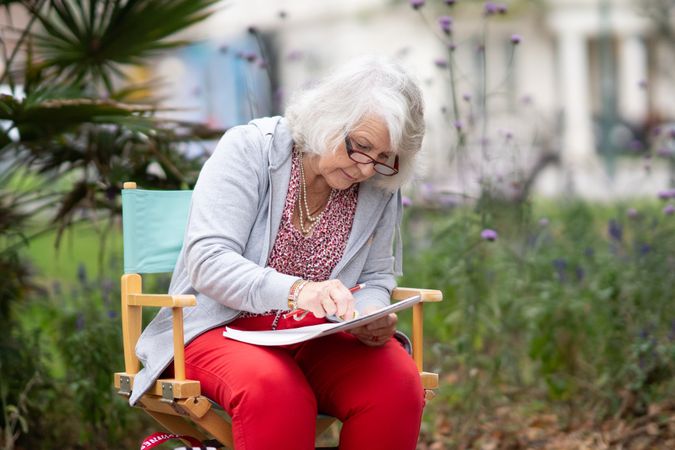 Woman sitting outside in park at drawing class