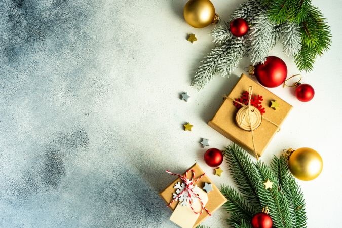 Top view of counter with fir branch and holiday baubles with copy space