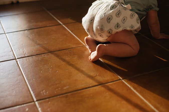 Baby crawling on all fours on floor