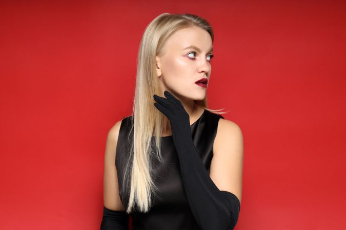 Concept of Halloween, young woman on red background
