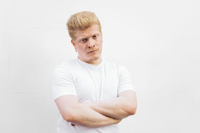 Monochrome: Portrait of a Latino man with albinism and t-shirt against a light background.