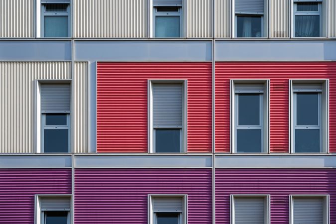 Facade of modern multicolored building with narrow windows