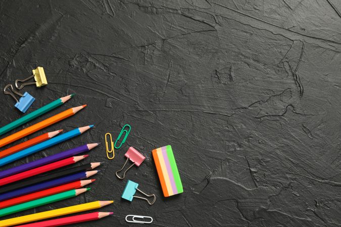 Composition with school supplies on dark background, space for text