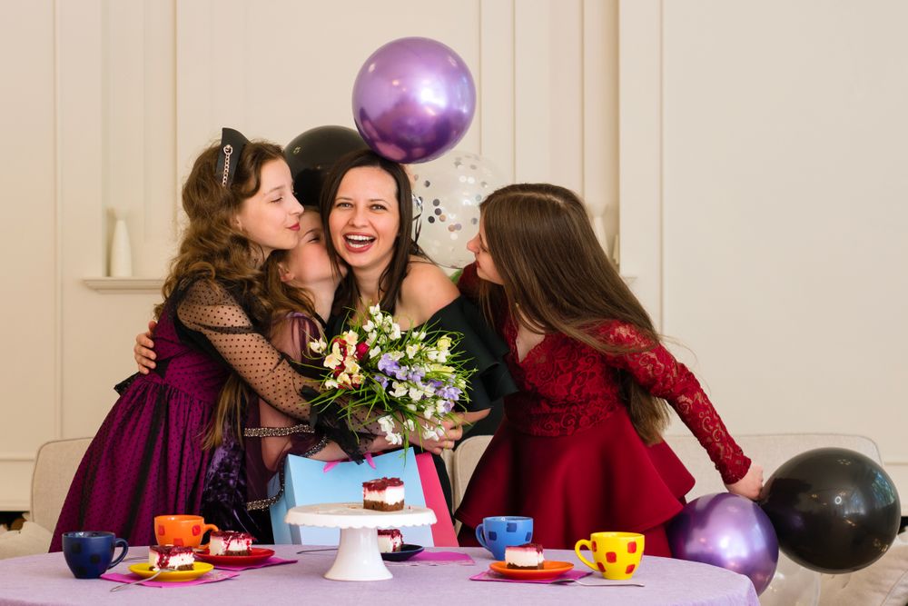 Woman and girls celebrating birthday party.