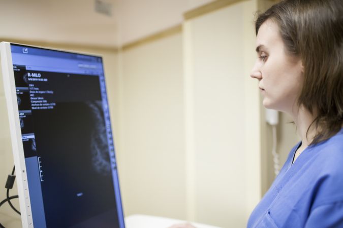 Female doctor using digital equipment for mammography