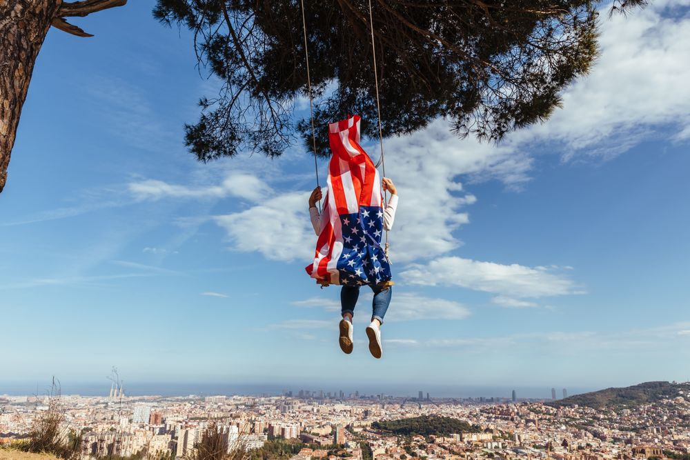 Female with American flag on swing