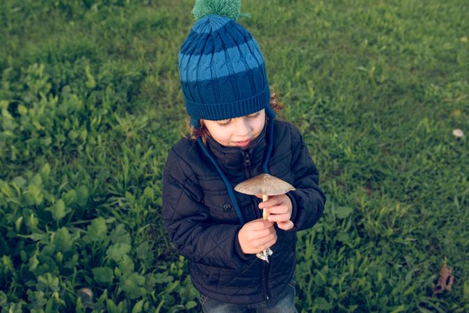 Boy with mushroom in nature