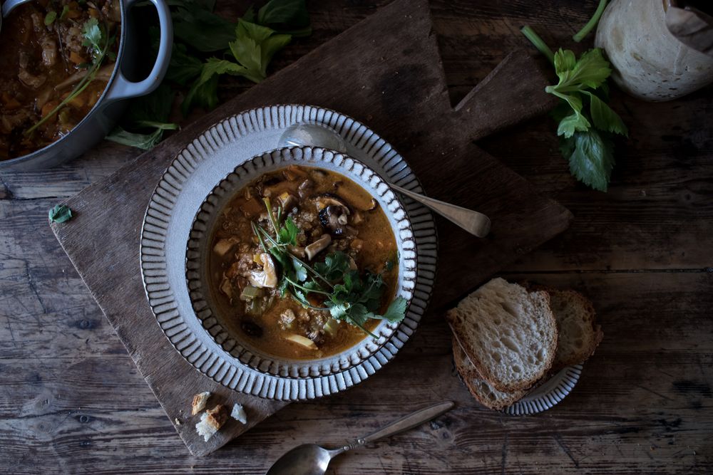Bread and parsley near quinoa soup