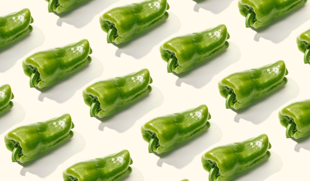 Rows of whole green peppers