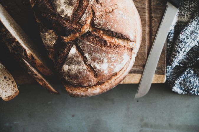 Freshly baked sourdough bread loaf, sliced, horizontal composition