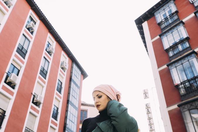 Contemporary woman on street against buildings