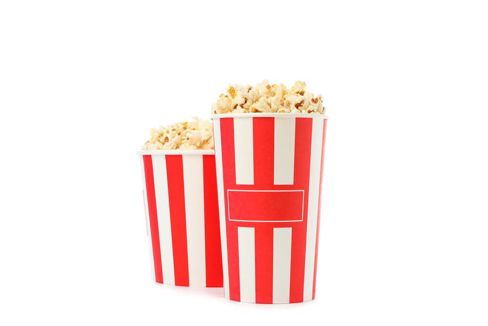 Striped buckets with popcorn isolated on plain background