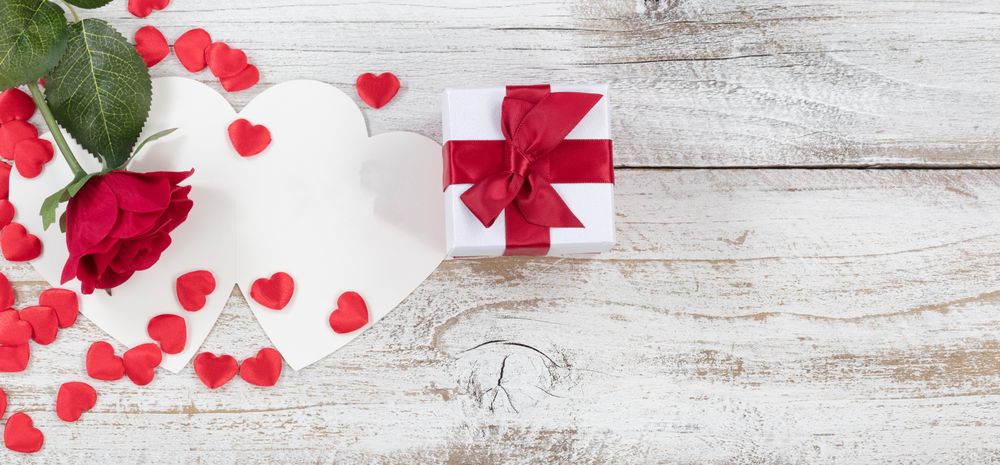 Valentine’s gift with card on rustic wood