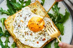 Delicious breakfast of fried eggs with toast and salad.