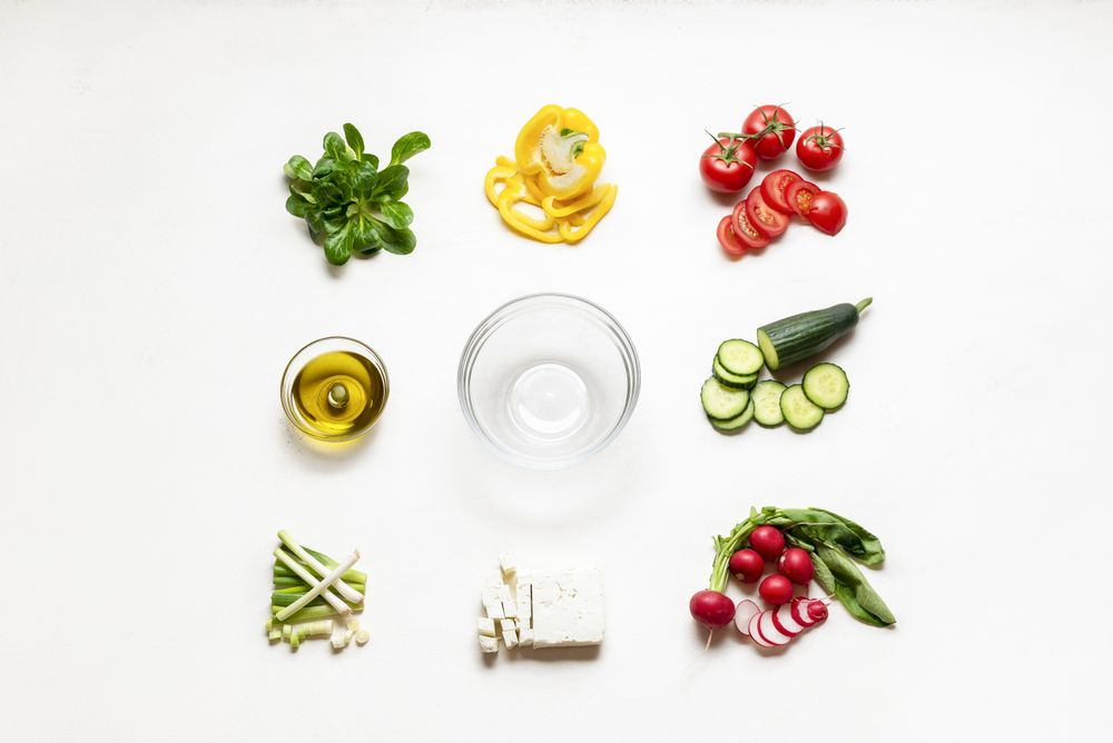 Salad ingredients and empty bowl