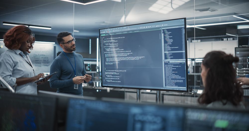 Group of Multiethnic Software Developers Having a Meeting in Order to Review the Code Done by Computer Engineering Department.