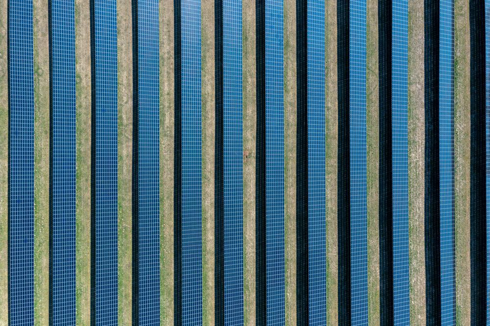 Solar panels in bright sunlight in Germany, drone aerial view