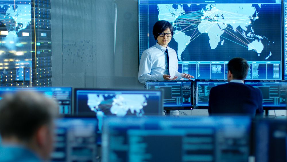 In the System Control Room Manager Holds a Briefing for His Staff Members.