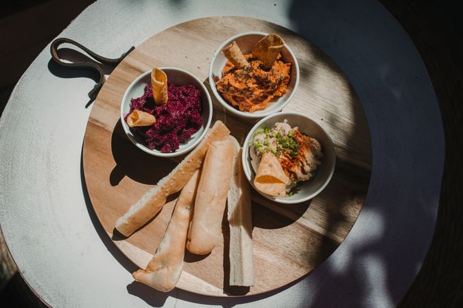 Different tasty sauces on round wooden stand