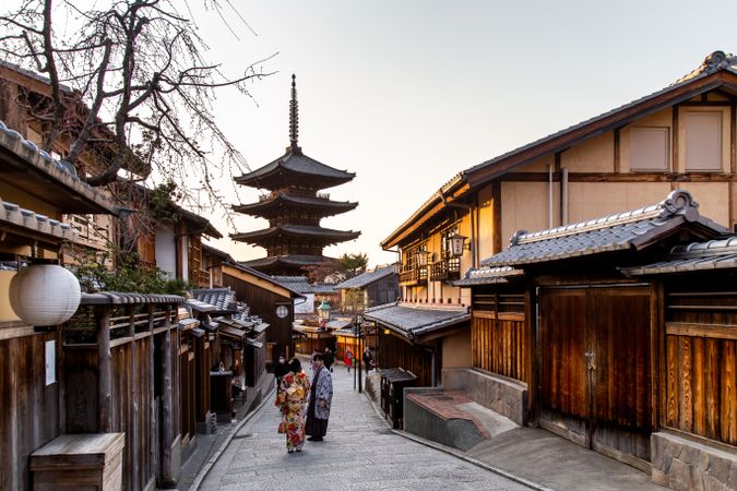 Back view of women in kimonos walking on Nineizaka an ancient pedestrian road in Higashiyama-ku, Kyoto, Japan