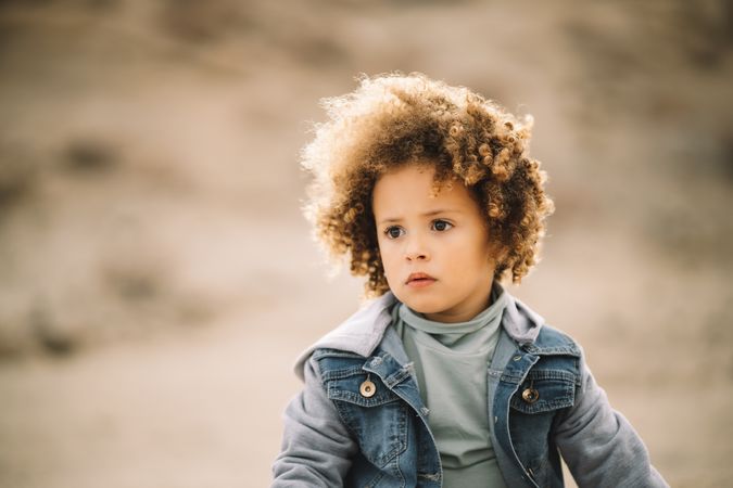 curly toddler on nature