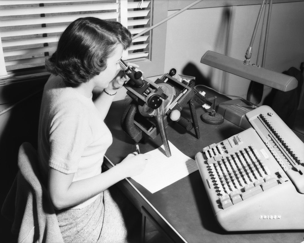 Mathematician at work with a microscope