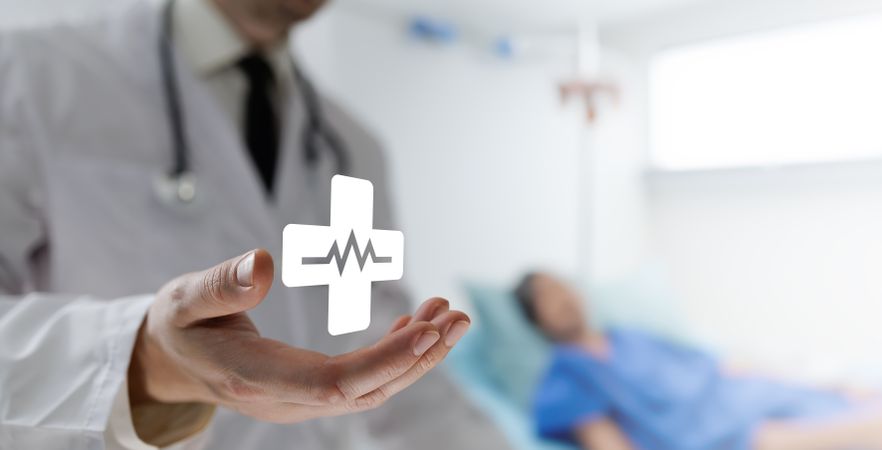 Doctor holds medical cross icon