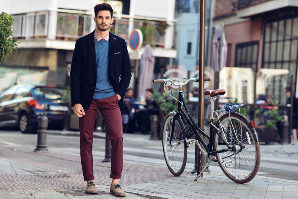 Man in the street wearing elegant suit next to parked vintage bicycle