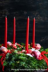 Top view of Christmas wreath with long red candles 0LlLP0