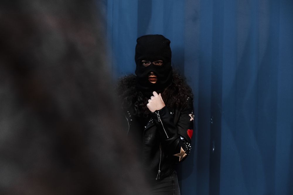 Woman in balaclava and leather jacket