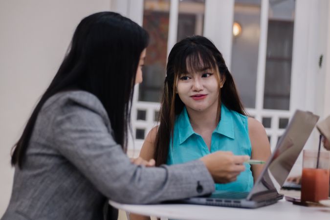 Teamwork Session, Two Businesswomen Collaborating on a Laptop