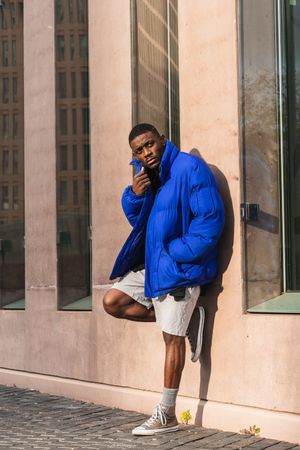 Black stylish man in warm jacket on street