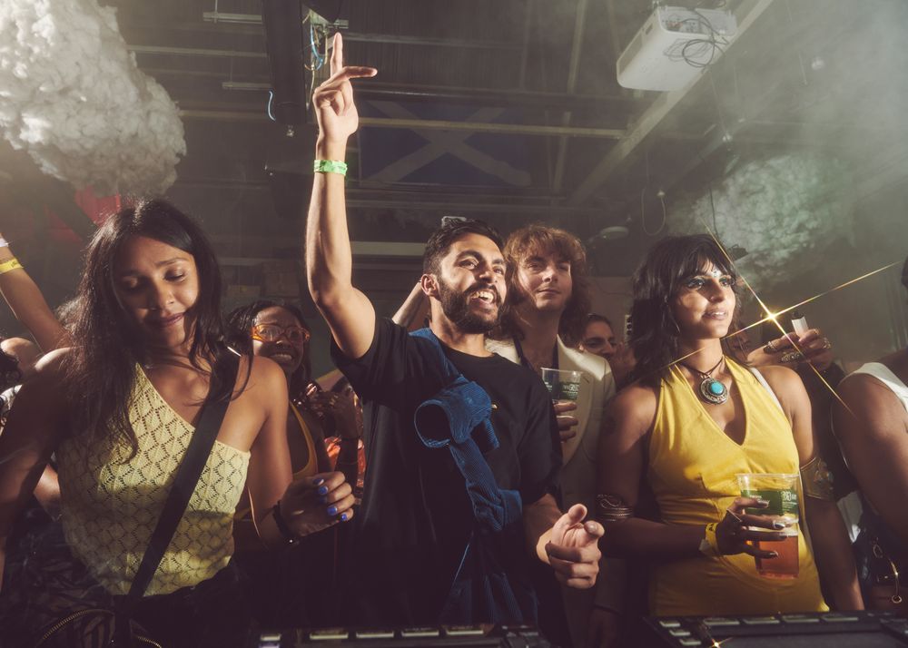 London, England, United Kingdom - Nov 9, 2022: Happy people dancing facing DJ