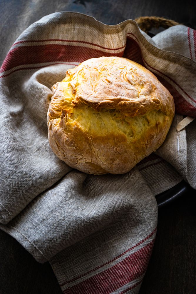 Freshly baked bread boule on a towel