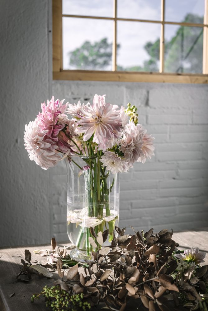 Bunches of flowers in vases on table