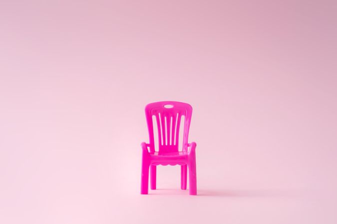 Pink outdoor chair on pink background