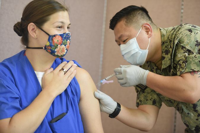 AGANA HEIGHTS, Guam - Jan 4, 2021: Lt. Cmdr. Allison Wessner, a pediatrician recieves vaccination