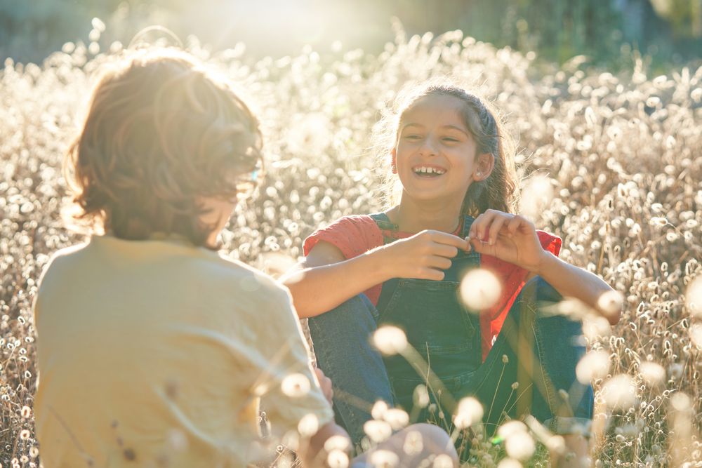 Smiling girl looking at friend in countryside