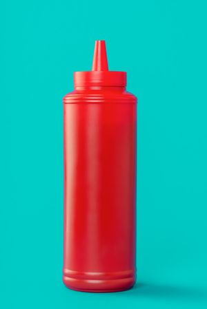 Ketchup plastic bottle isolated on a blue background