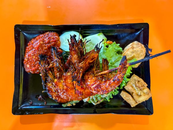 top view of Grilled Prawns Served with Vegetables, Chili Sauce, and Fried Tofu