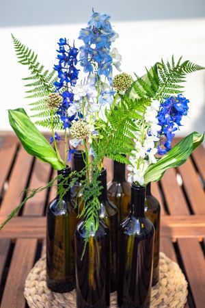 Summer flower composition with vases of blue flowers