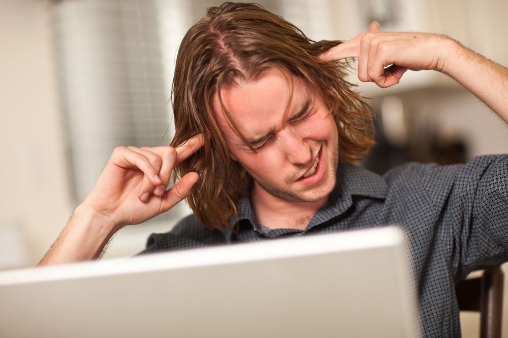 Young Man Getting Loopy While Using Laptop Computer